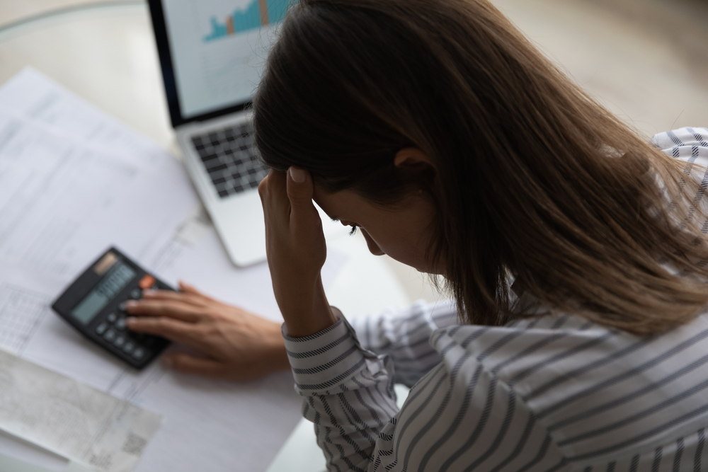 Above,top,close,up,back,view,frustrated,young,woman,calculating